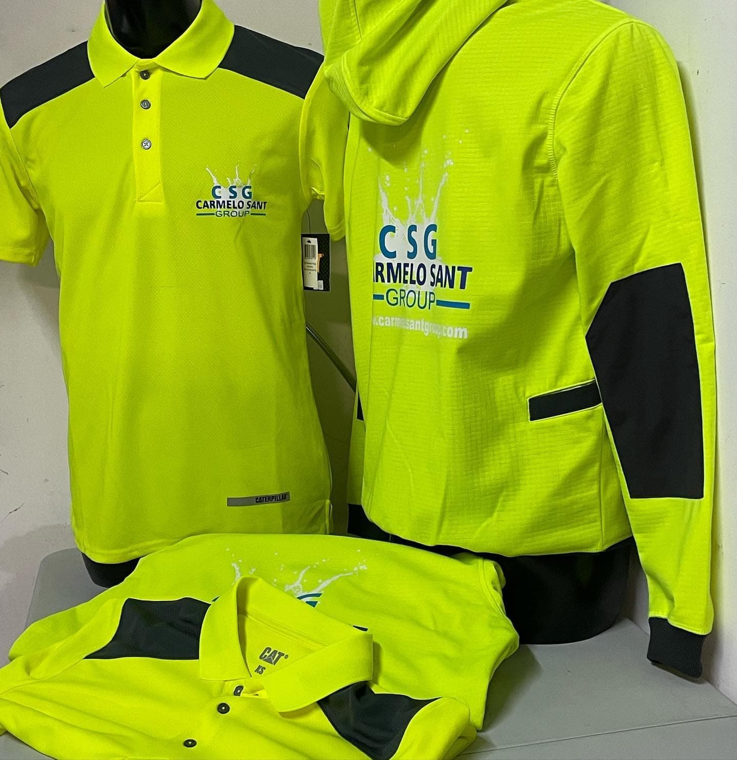 Yellow Carmelo Sant Group hi-vis polos and hoodie with the group logo
