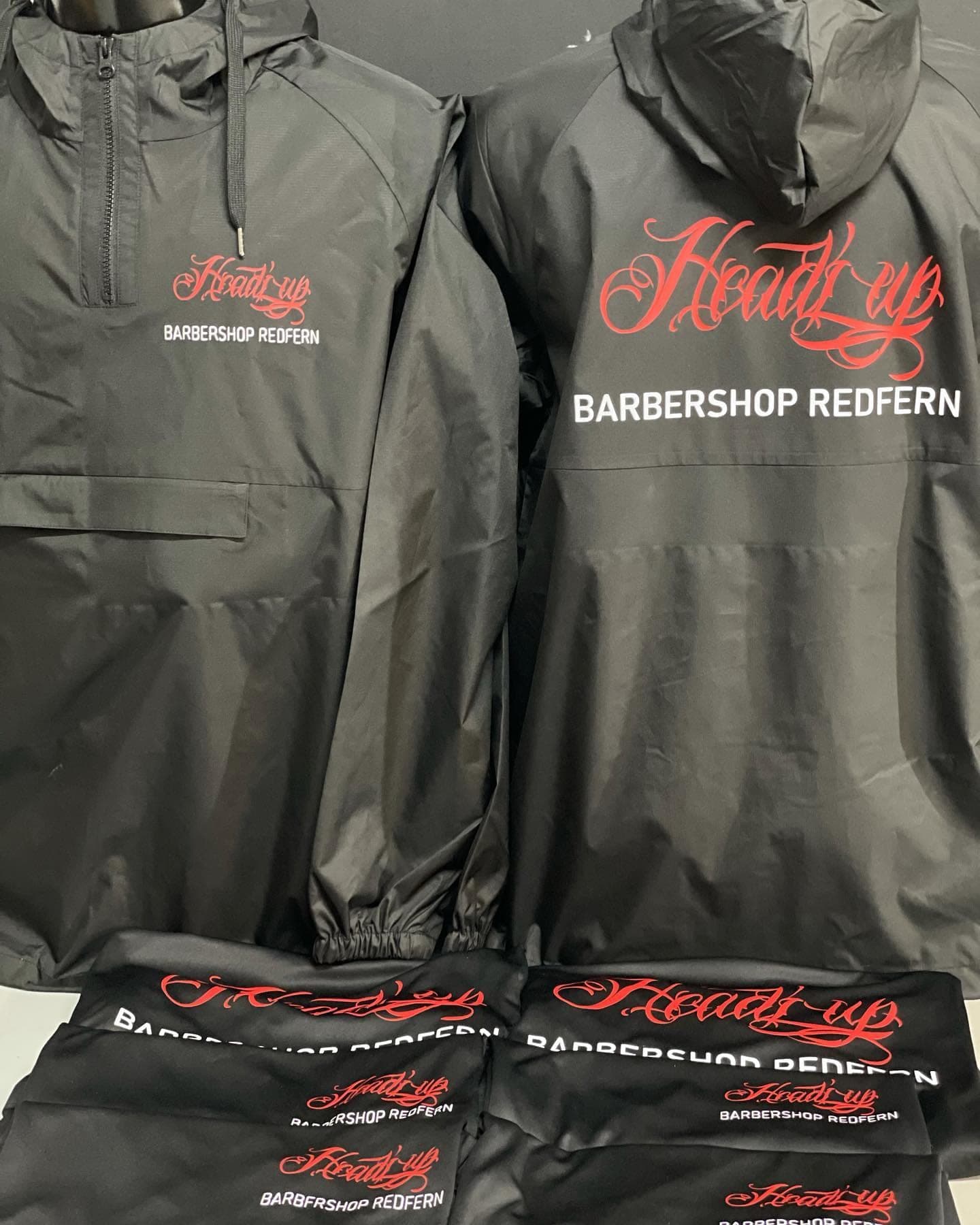 Black Headz Up Barbershop Redfern jackets with a red script logo on the chest and a large back print