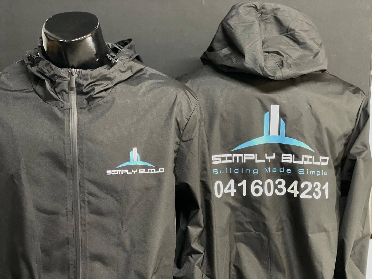 Black Simply Build hooded jackets with a small chest logo and large back logo and phone number